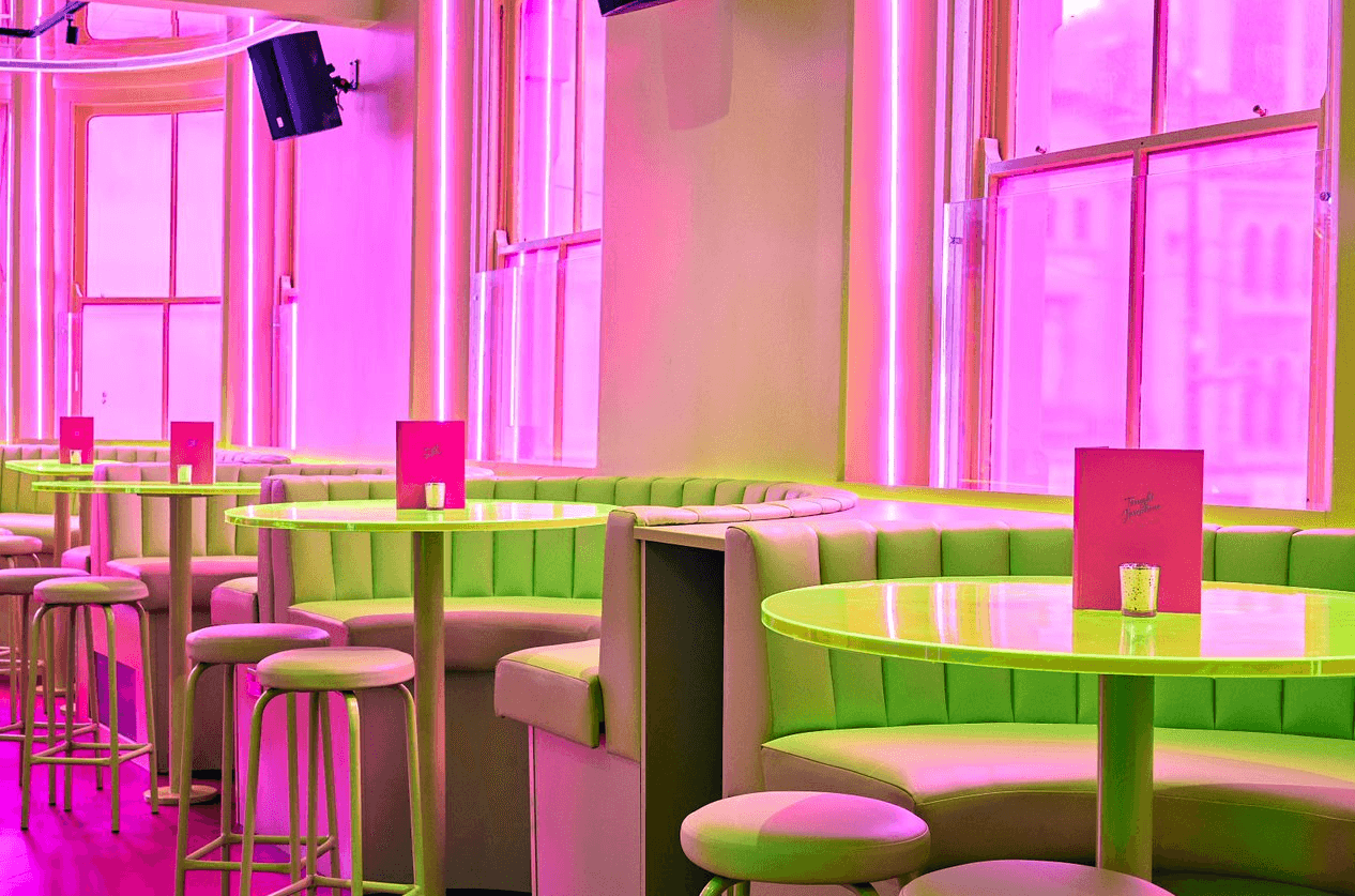 Booth seating and green tables with pink menus in Tonight Josephine Cardiff