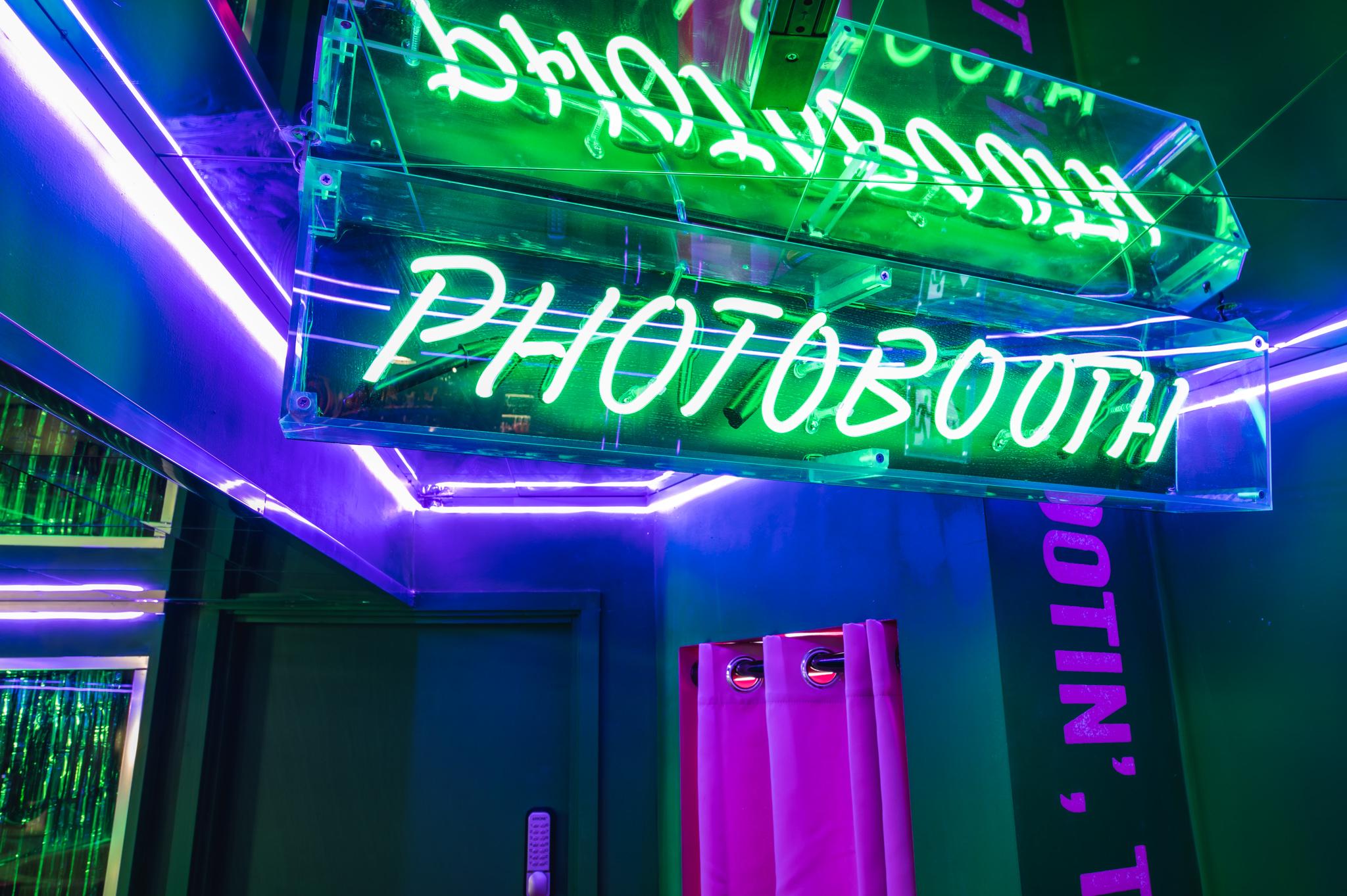 Green neon photobooth sign in TJ Bristol